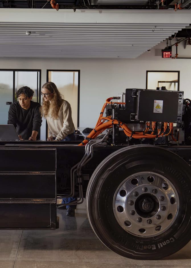 A group of people standing next to a large black truck