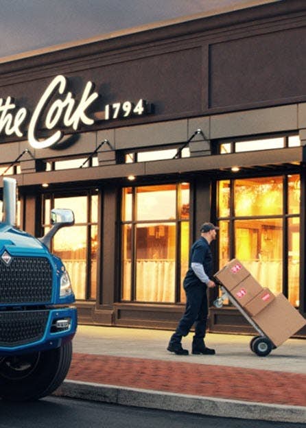 A blue truck parked in front of a building