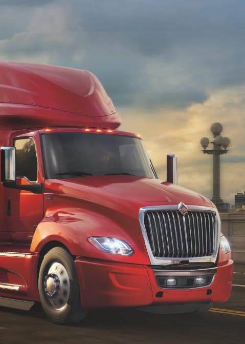 Red International Truck Driving Down Highway