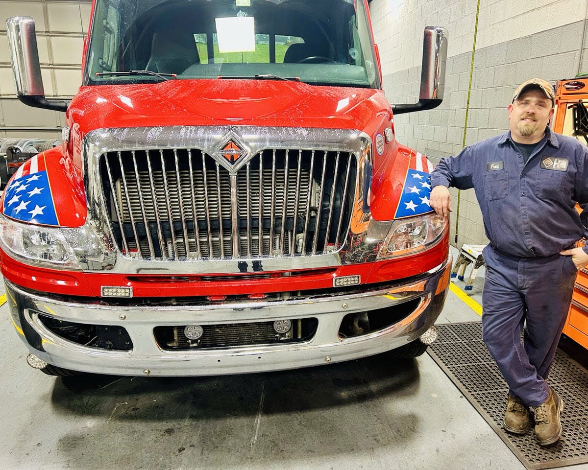 A person standing next to a truck