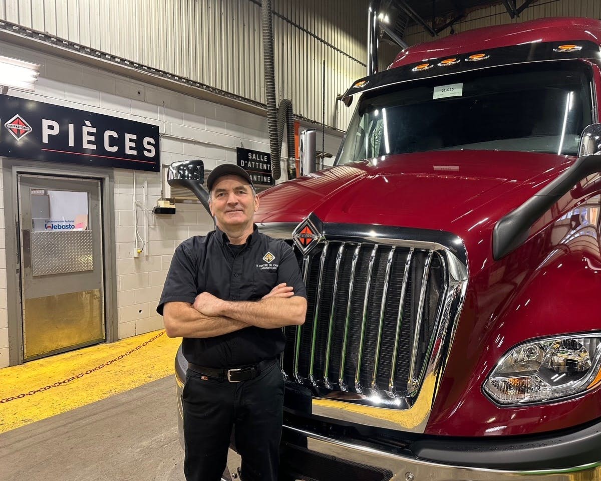 A person standing next to a truck
