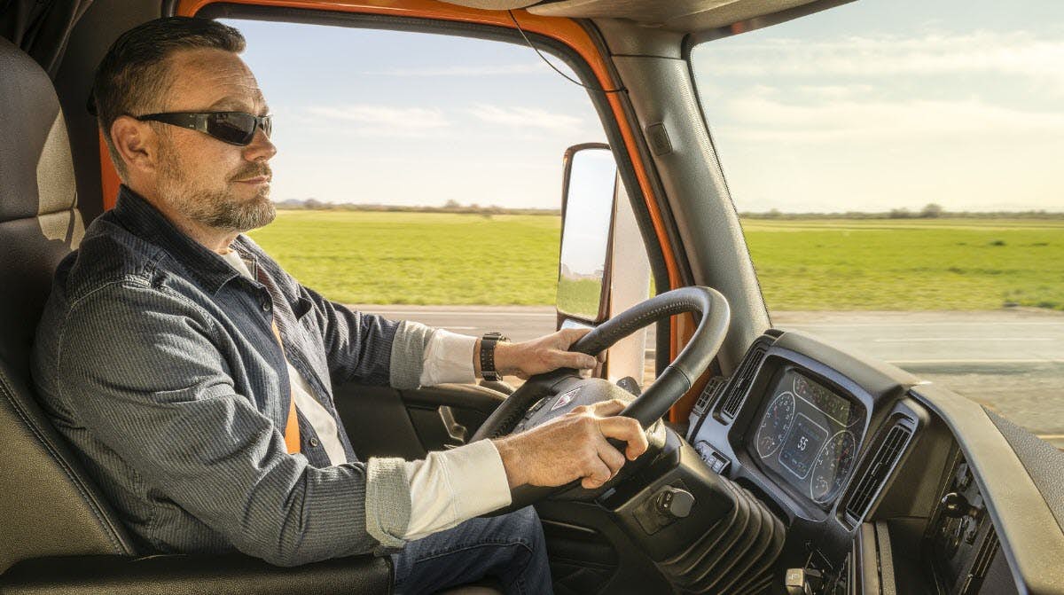 Truck driver in cab of truck