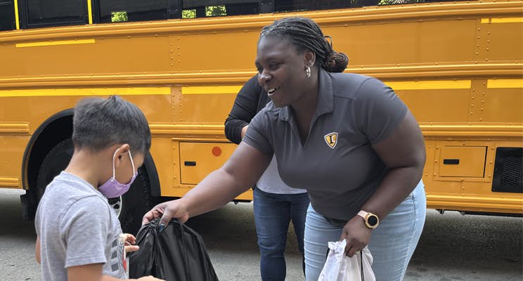 A person and a child getting a bag of food