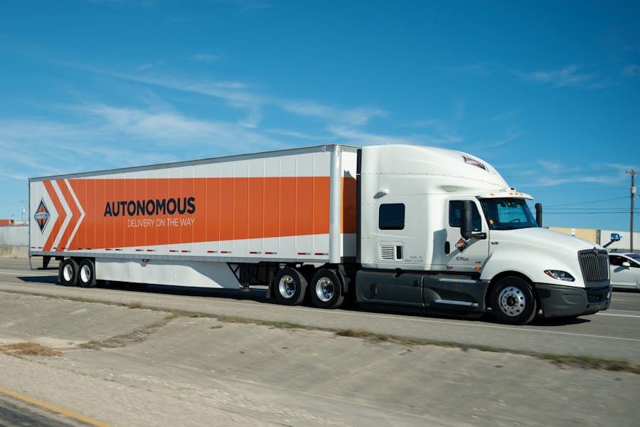 A white and orange semi truck