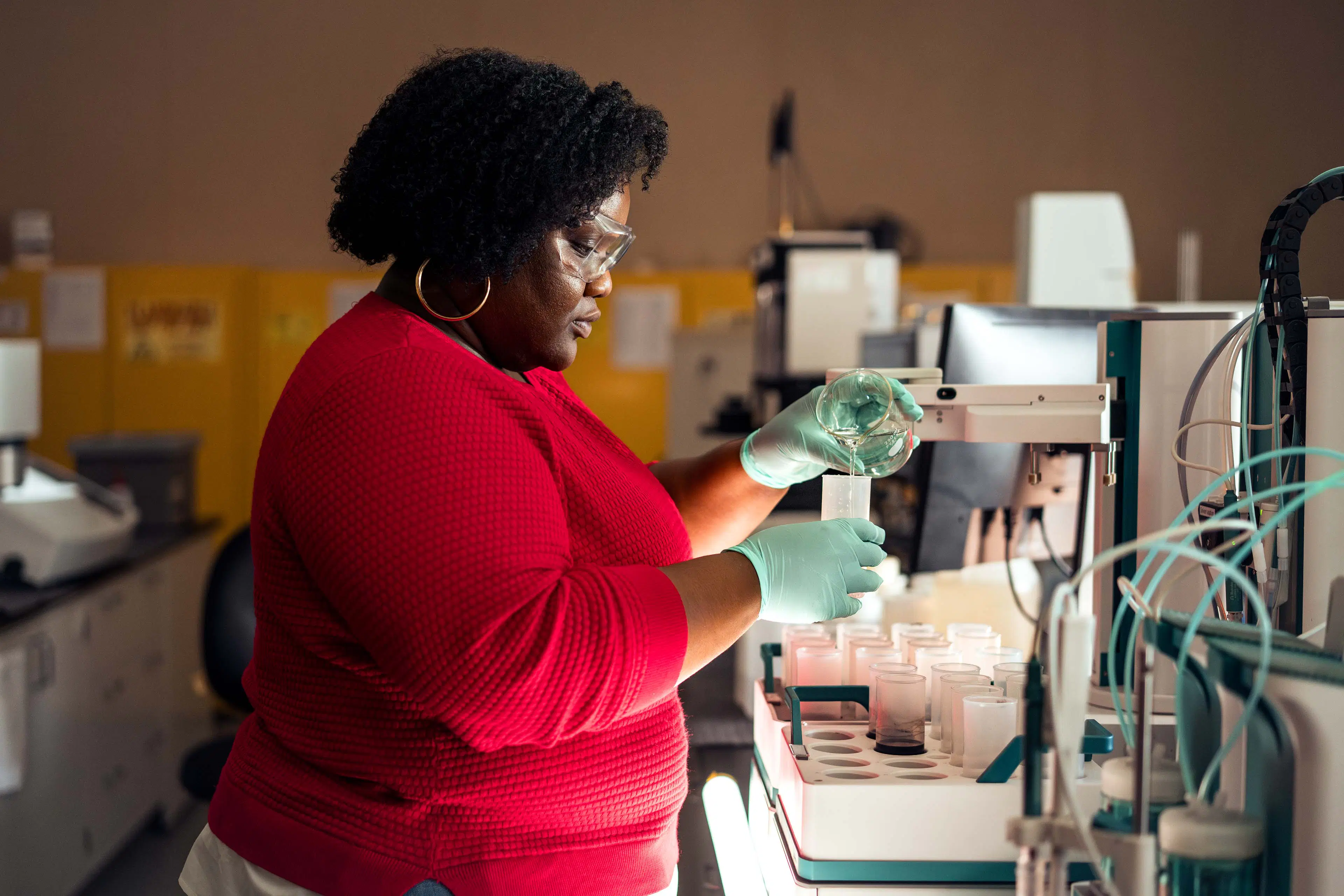 A woman working in a lab testing chemicals