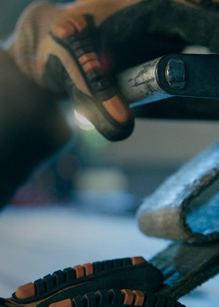 Person wearing gloves working on mechanics