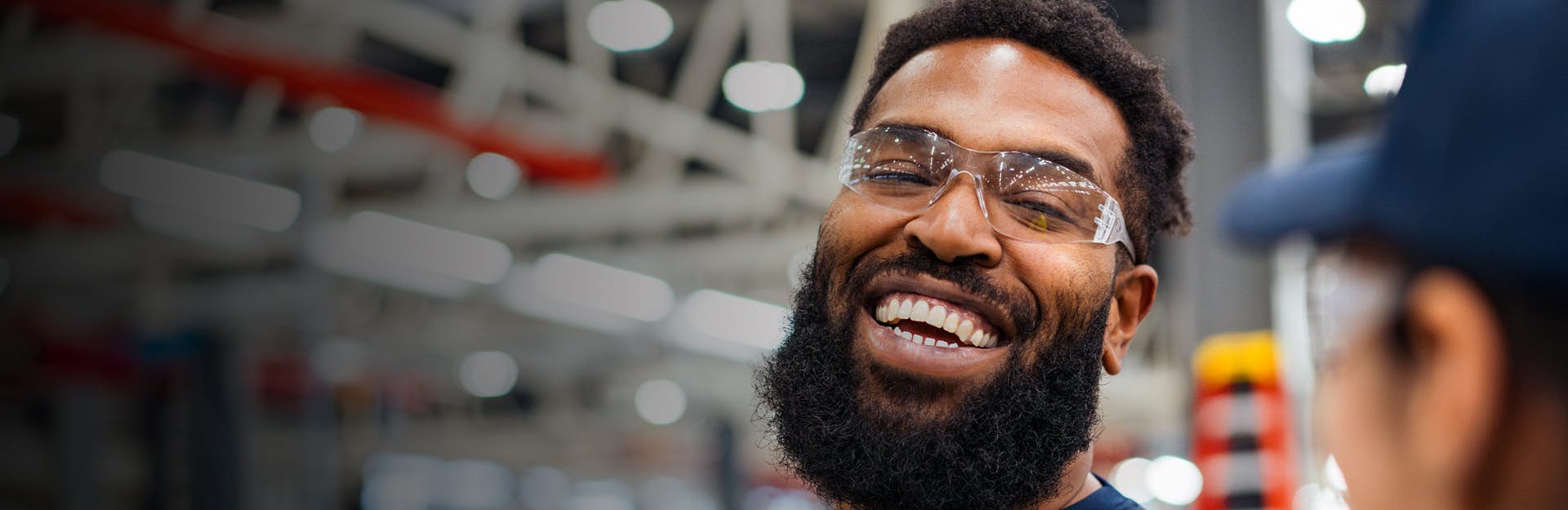 Employee wearing safety glasses laughing