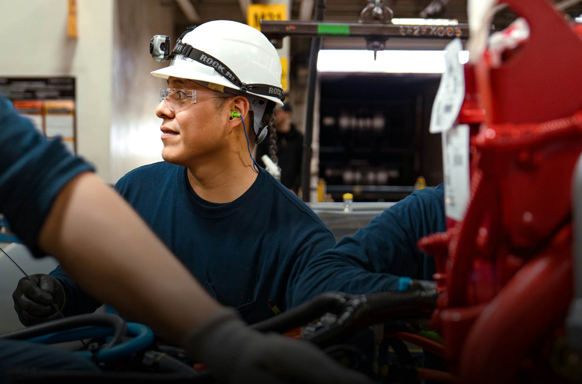 A person wearing a construction hat
